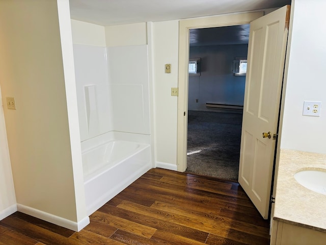 bathroom with baseboard heating, vanity, and wood-type flooring