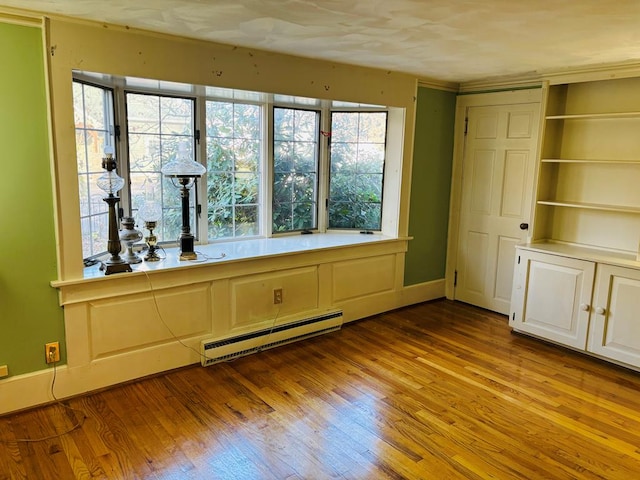 spare room with light hardwood / wood-style flooring and a baseboard radiator