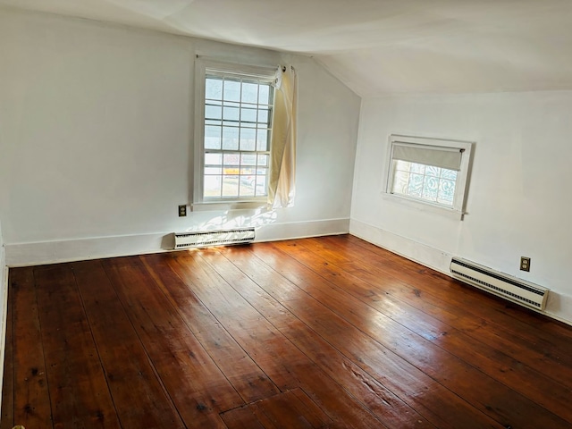 additional living space with a baseboard radiator, hardwood / wood-style flooring, and lofted ceiling