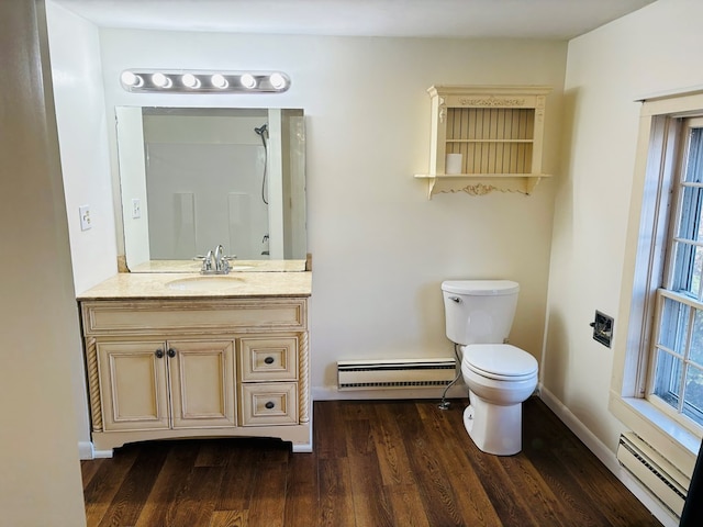 bathroom featuring hardwood / wood-style floors, toilet, vanity, and a baseboard radiator