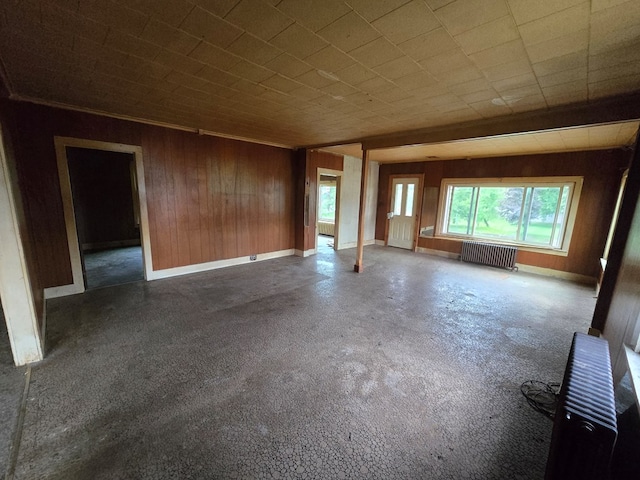 118 Wilbur St, Waverly, NY 14892 - spare room with radiator heating unit, wooden walls, and baseboards