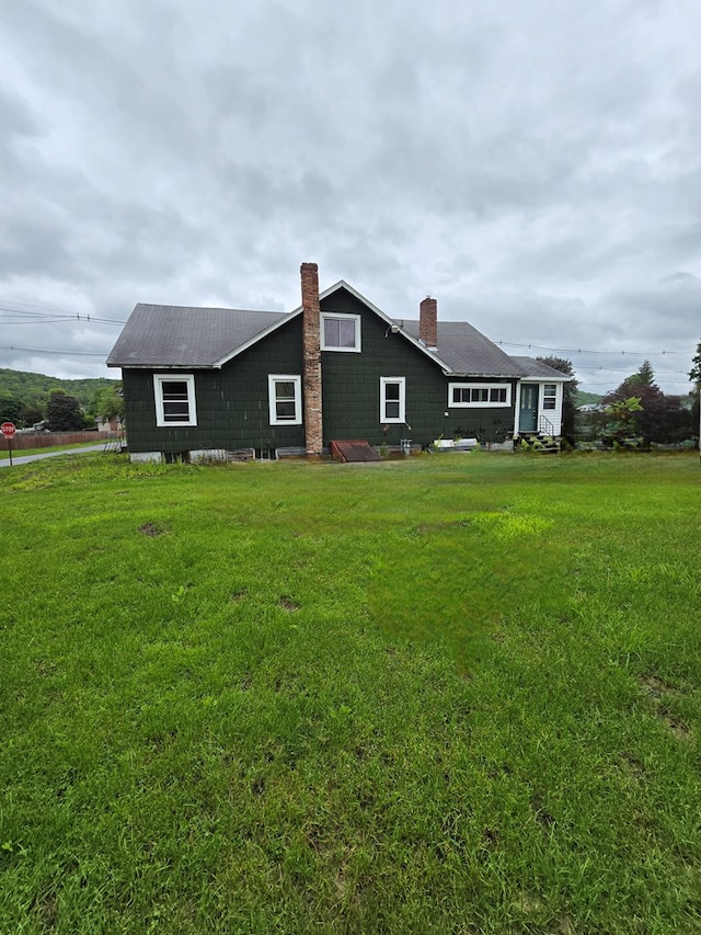 118 Wilbur St, Waverly, NY 14892 - rear view of house featuring a chimney and a yard