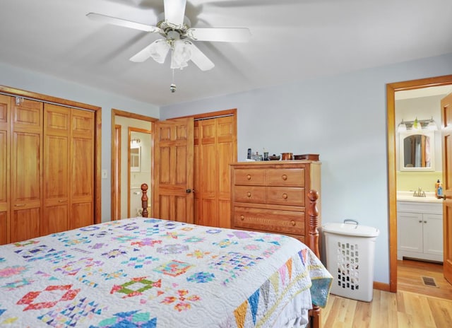 1817 Cotton Hollow Rd, Athens, PA 18810 - bedroom featuring two closets, light wood-style floors, a sink, a ceiling fan, and ensuite bath