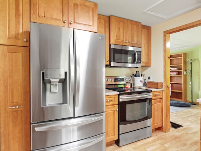 1817 Cotton Hollow Rd, Athens, PA 18810 - kitchen featuring stainless steel appliances, light countertops, light wood-style flooring, and brown cabinets