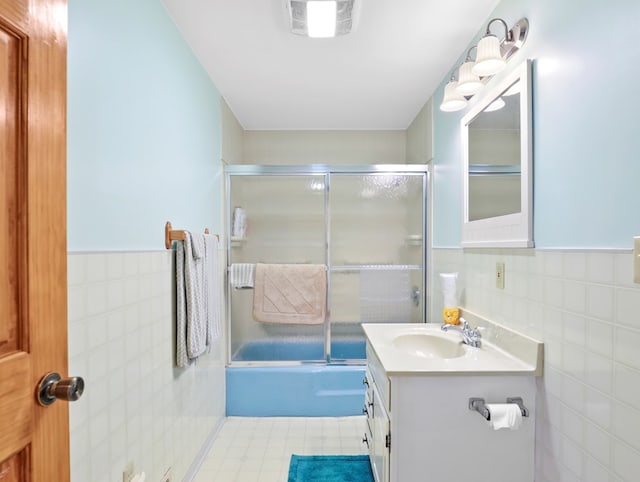 1817 Cotton Hollow Rd, Athens, PA 18810 - bathroom featuring tile walls, vanity, bath / shower combo with glass door, and a wainscoted wall