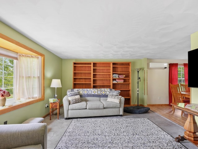 1817 Cotton Hollow Rd, Athens, PA 18810 - living room featuring a wall unit AC, plenty of natural light, and baseboards