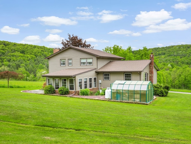 1817 Cotton Hollow Rd, Athens, PA 18810 - rear view of property featuring an exterior structure, a chimney, a view of trees, and an outdoor structure