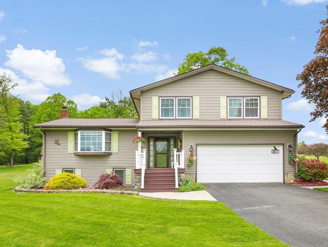 1817 Cotton Hollow Rd, Athens, PA 18810 - view of front of home with a garage, asphalt driveway, a front yard, and a chimney