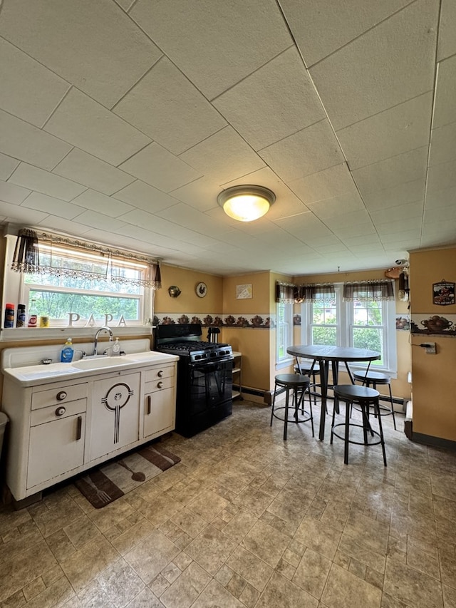 66 Benton St, Port Allegany, PA 16743 - kitchen featuring black gas stove, plenty of natural light, white cabinetry, and light countertops