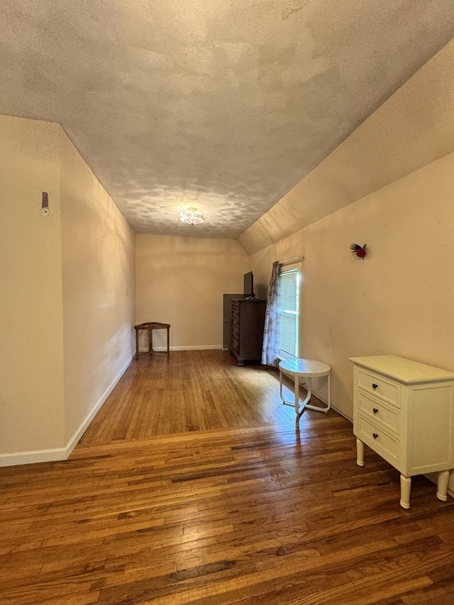 66 Benton St, Port Allegany, PA 16743 - additional living space featuring a textured ceiling, wood-type flooring, and vaulted ceiling