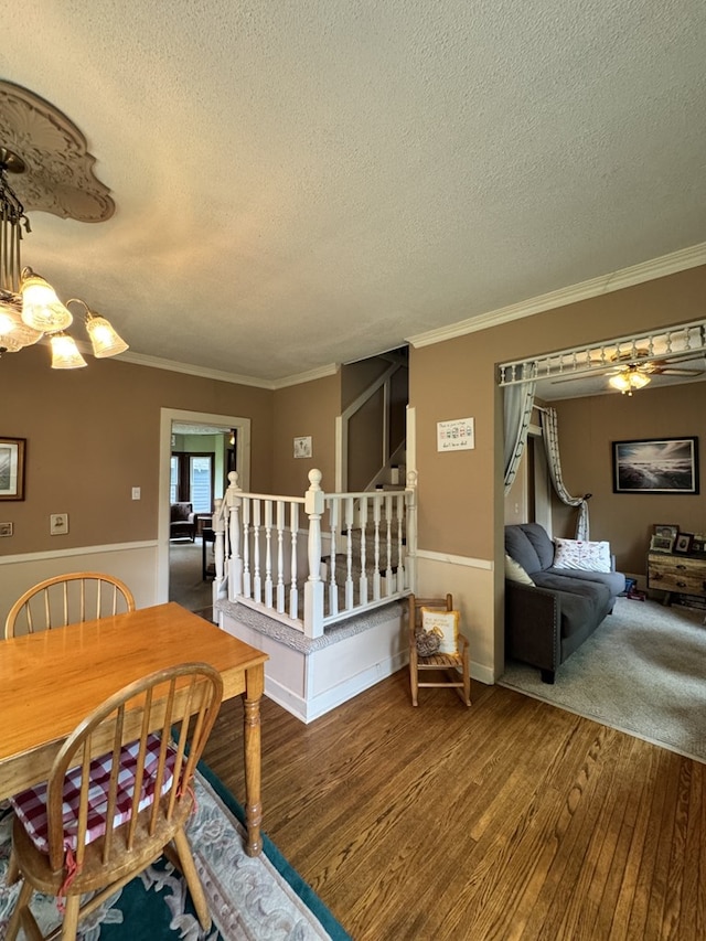 66 Benton St, Port Allegany, PA 16743 - dining space with a textured ceiling, wood finished floors, a chandelier, ornamental molding, and stairway