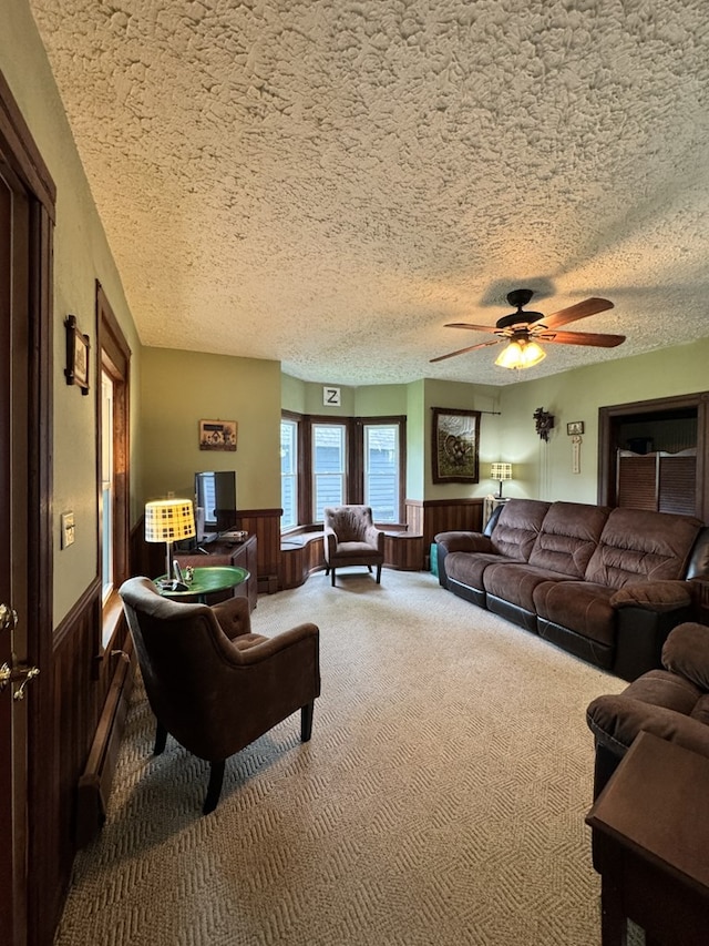 66 Benton St, Port Allegany, PA 16743 - carpeted living room with wainscoting, ceiling fan, a textured ceiling, and wooden walls