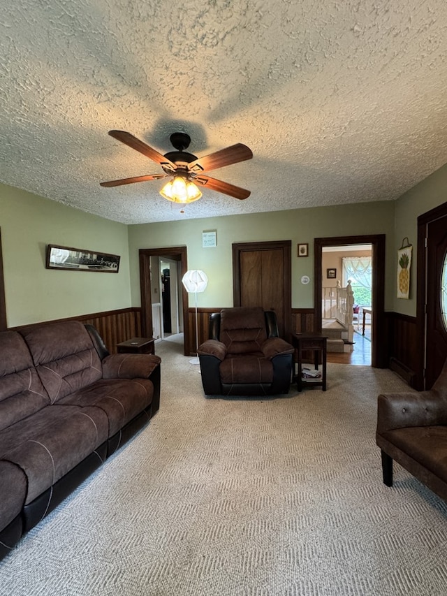 66 Benton St, Port Allegany, PA 16743 - carpeted living room with a wainscoted wall, a textured ceiling, and ceiling fan