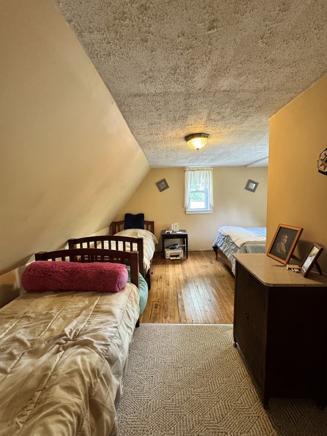 66 Benton St, Port Allegany, PA 16743 - bedroom featuring hardwood / wood-style floors, vaulted ceiling, and a textured ceiling