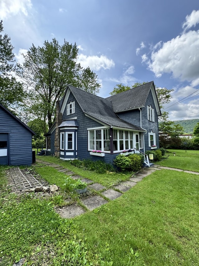 66 Benton St, Port Allegany, PA 16743 - view of side of property featuring roof with shingles and a lawn