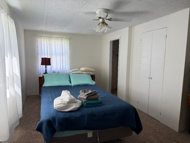 carpeted bedroom with ceiling fan