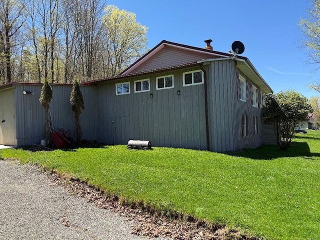 view of side of home with a lawn