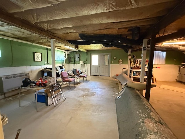 basement with concrete block wall and electric panel