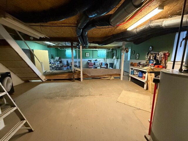 unfinished basement featuring water heater