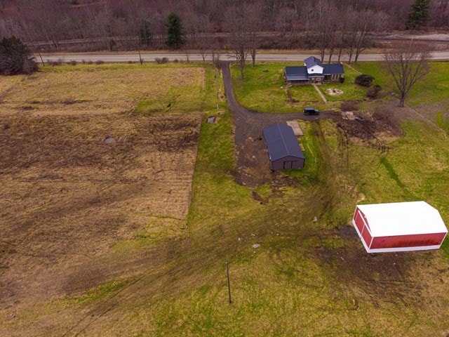 birds eye view of property with a rural view