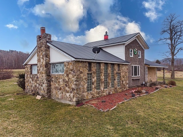 view of property exterior featuring a lawn