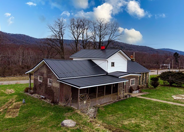 exterior space featuring a mountain view and a front yard