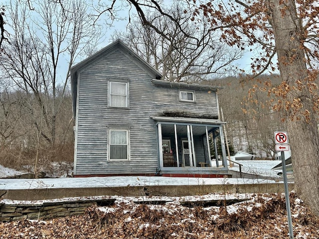 snow covered house with covered porch