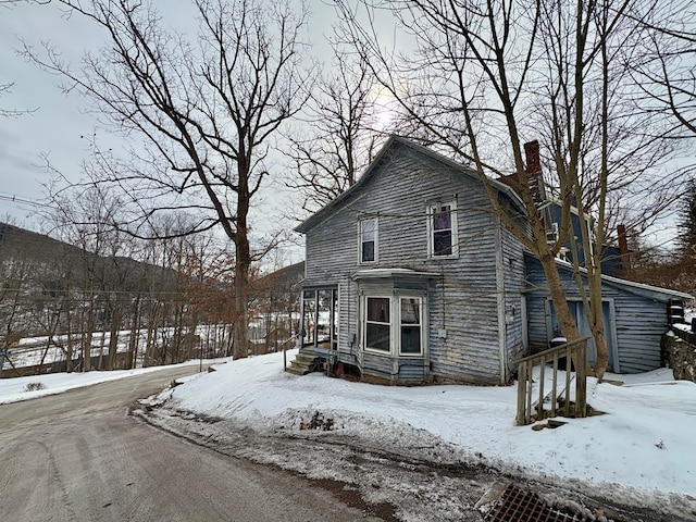 view of front of house featuring a chimney