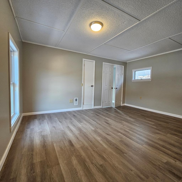 unfurnished room featuring hardwood / wood-style flooring and a textured ceiling