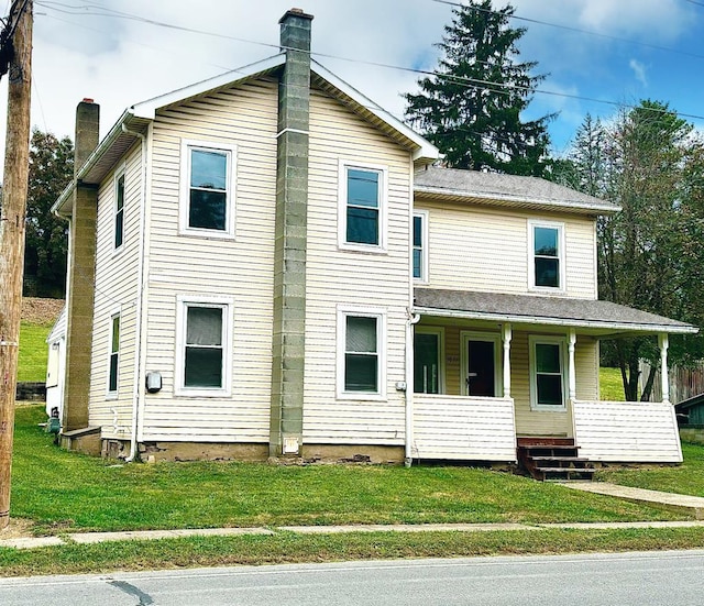 view of front of home with covered porch and a front yard