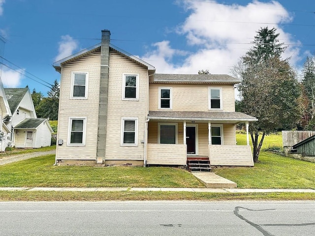 front of property featuring a front yard and covered porch