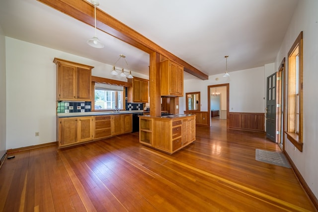 kitchen featuring tasteful backsplash, dishwasher, dark hardwood / wood-style flooring, and pendant lighting