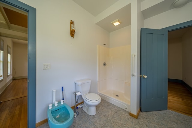 bathroom with a shower, a bidet, and toilet