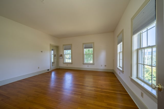 spare room with dark wood-type flooring