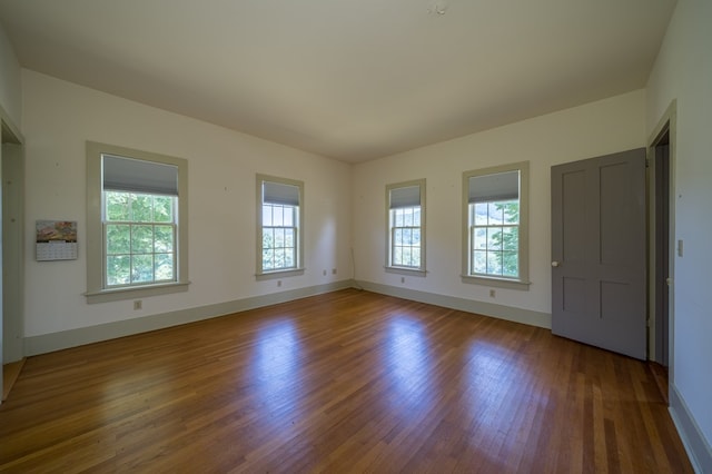 empty room with dark hardwood / wood-style floors