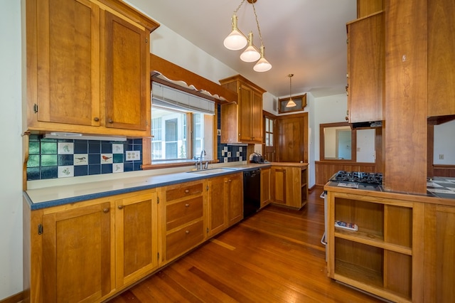 kitchen with sink, dark wood-type flooring, hanging light fixtures, black dishwasher, and decorative backsplash