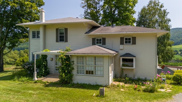 back of house with a lawn