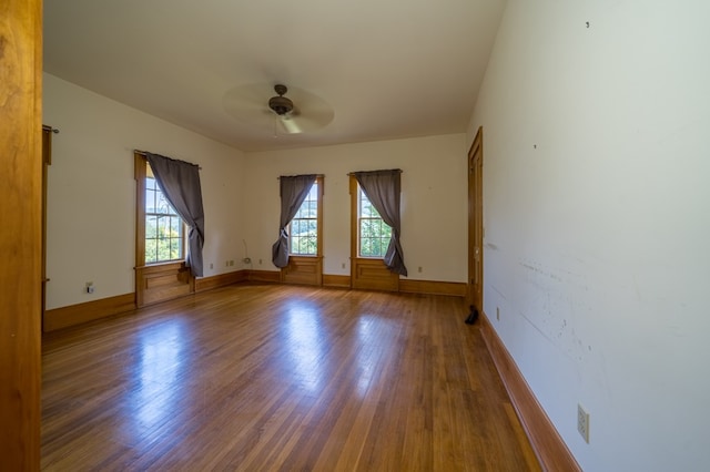 unfurnished room with ceiling fan and wood-type flooring