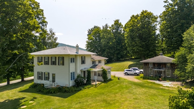 back of property featuring a lawn