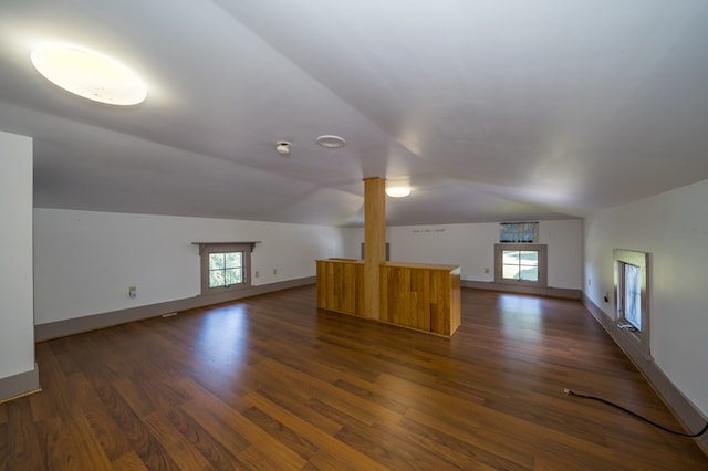 bonus room featuring dark wood-type flooring, a wealth of natural light, and vaulted ceiling