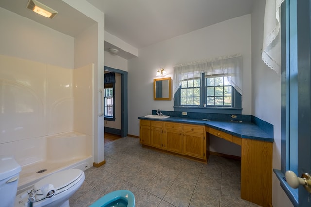 bathroom with a shower, tile patterned floors, vanity, and toilet