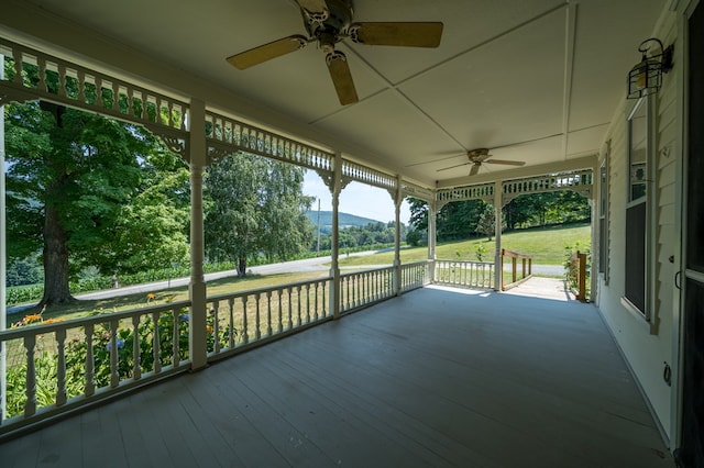 unfurnished sunroom featuring plenty of natural light and ceiling fan