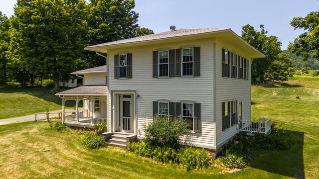 colonial house with a porch and a front yard