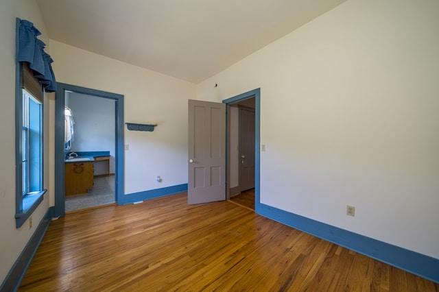 unfurnished bedroom featuring hardwood / wood-style flooring