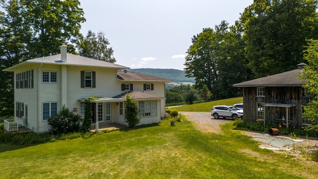 rear view of house with a yard