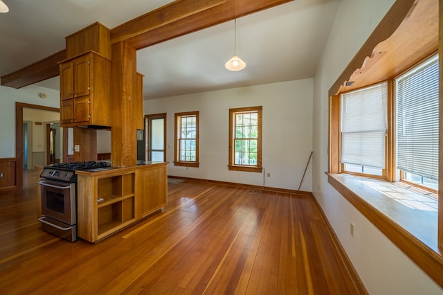 kitchen featuring gas stove, dark hardwood / wood-style floors, and hanging light fixtures