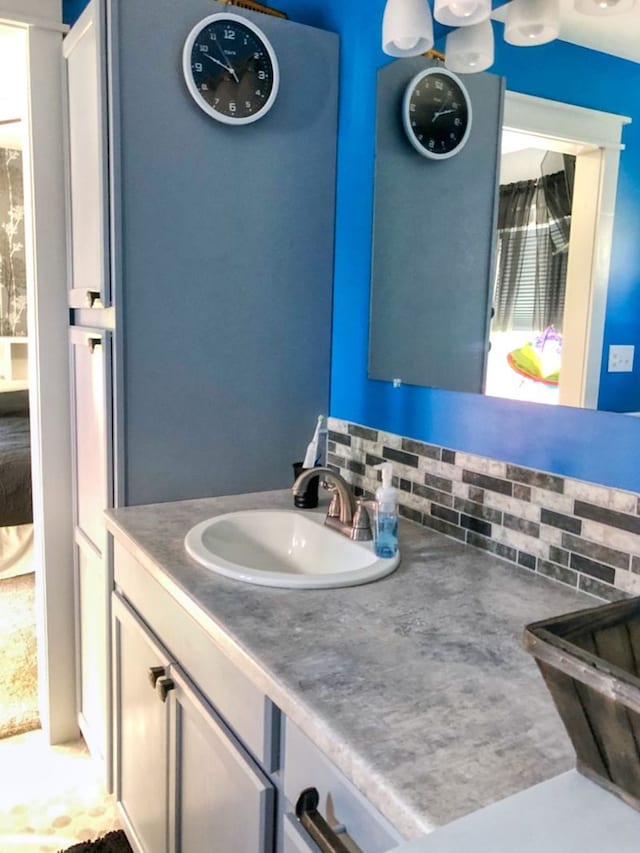 bathroom with tasteful backsplash, a wealth of natural light, and vanity