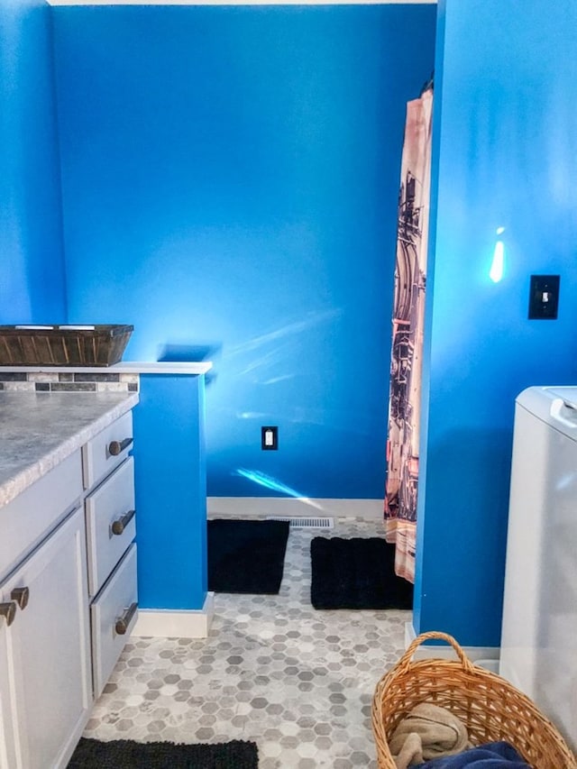 bathroom with washer / dryer and vanity