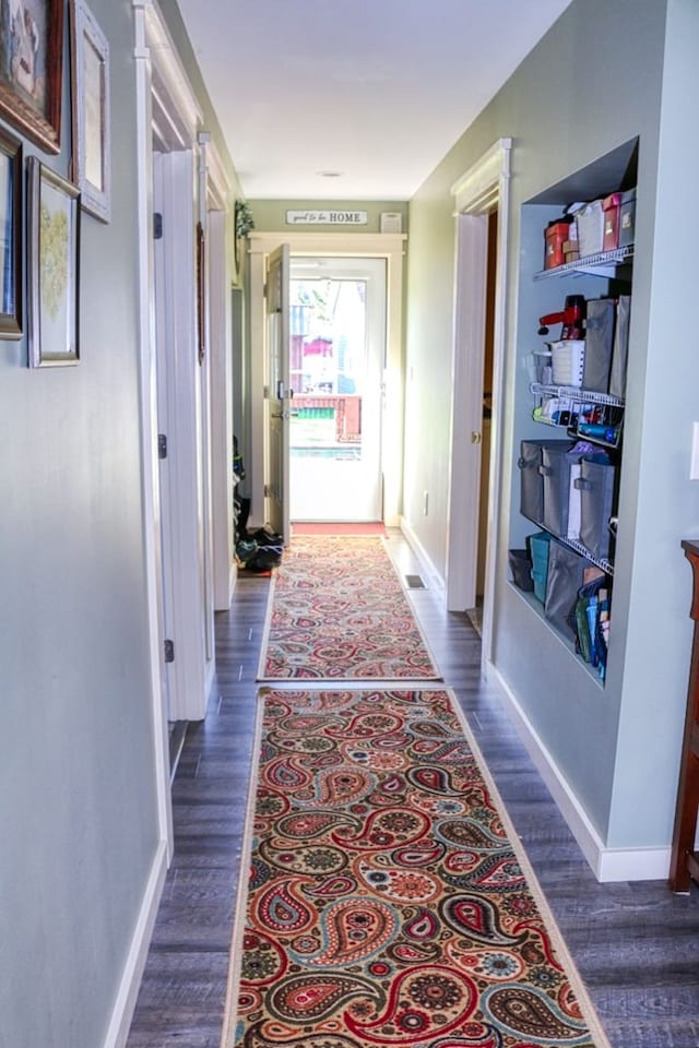 hall with dark hardwood / wood-style flooring