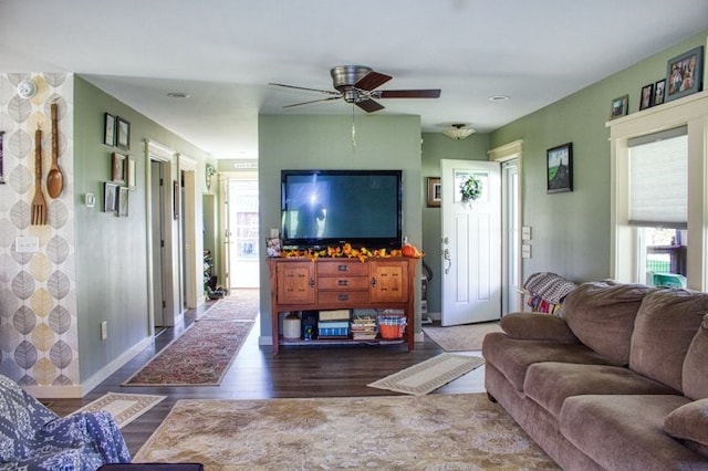 living room featuring ceiling fan and dark hardwood / wood-style flooring